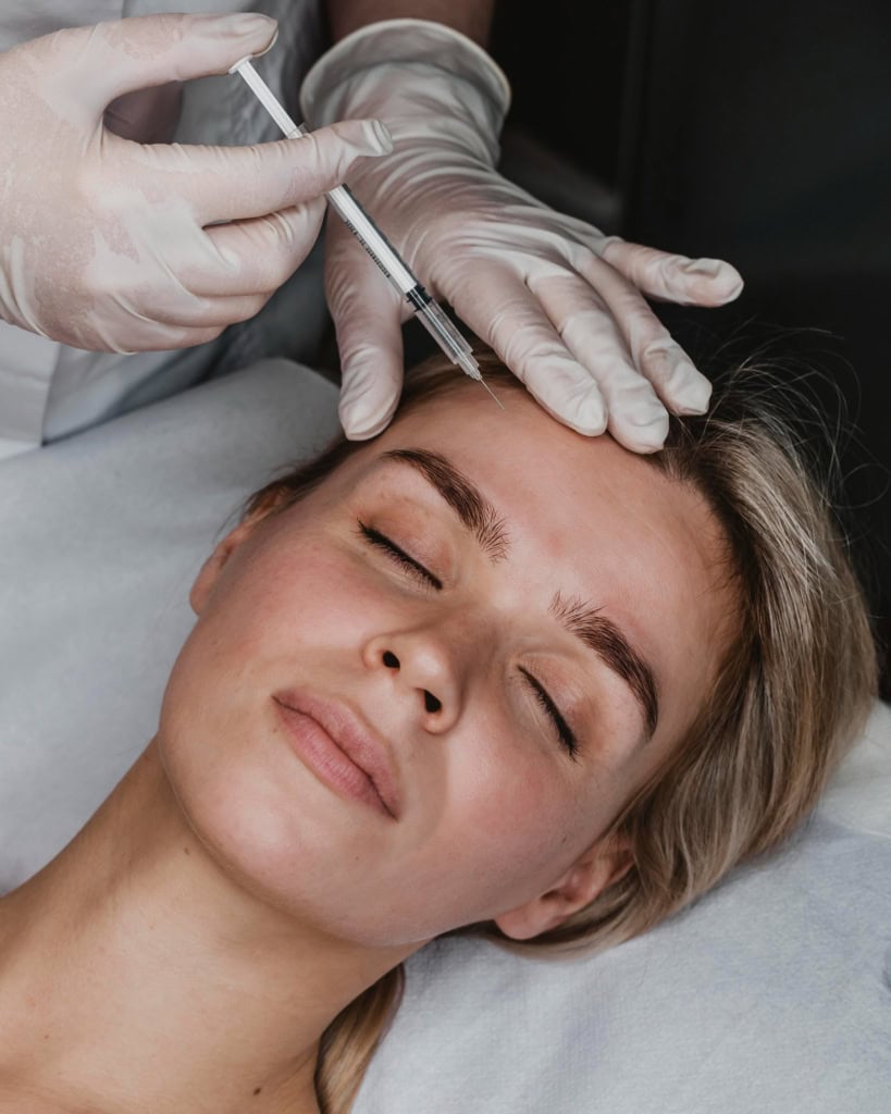 Female patient receiving a botox injection on forehead
